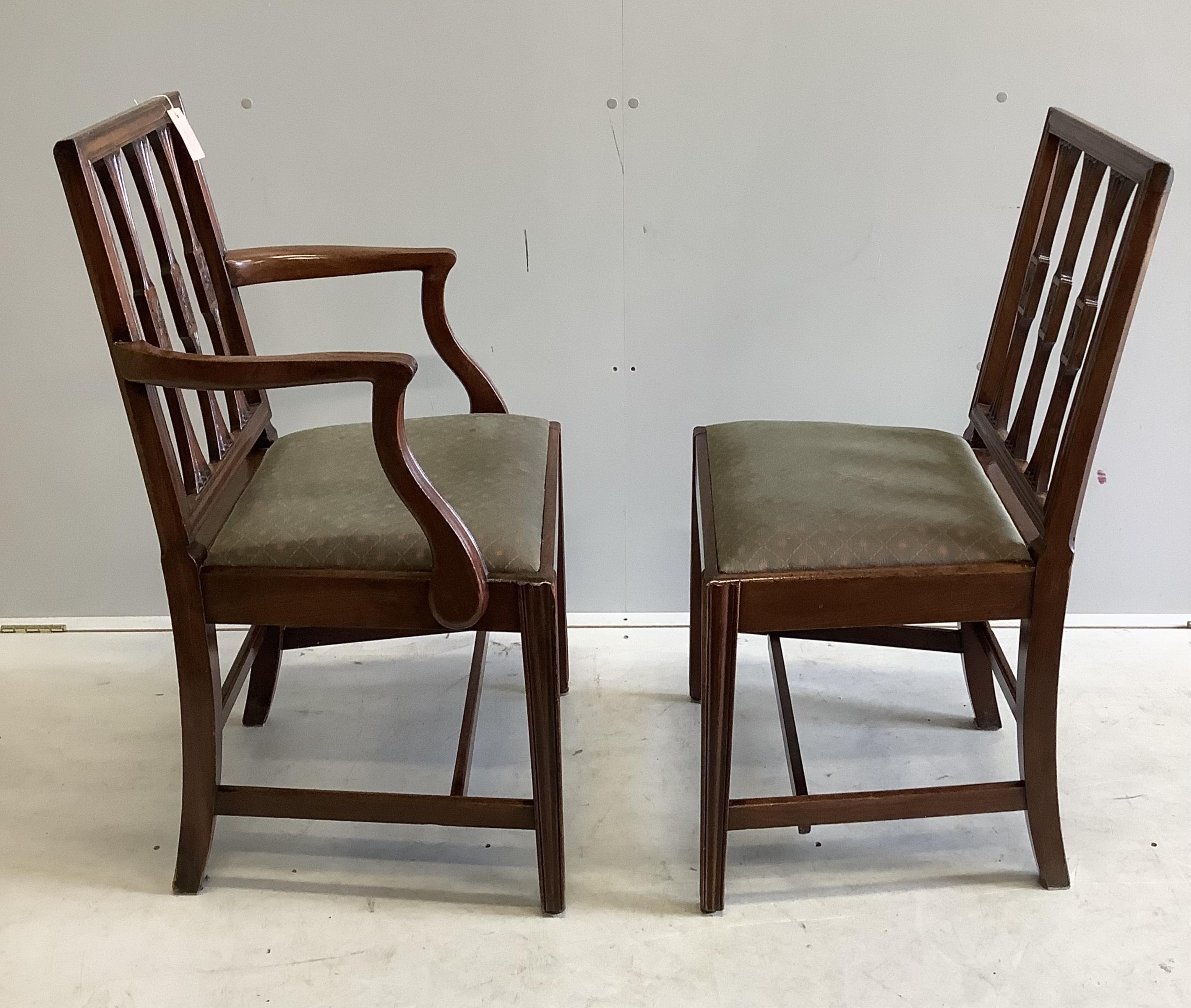 A set of ten Sheraton style mahogany dining chairs, two with arms together with a reproduction banded mahogany twin pillar extending dining table, 300cm extended, depth 91cm, height 72cm. Condition - fair to good